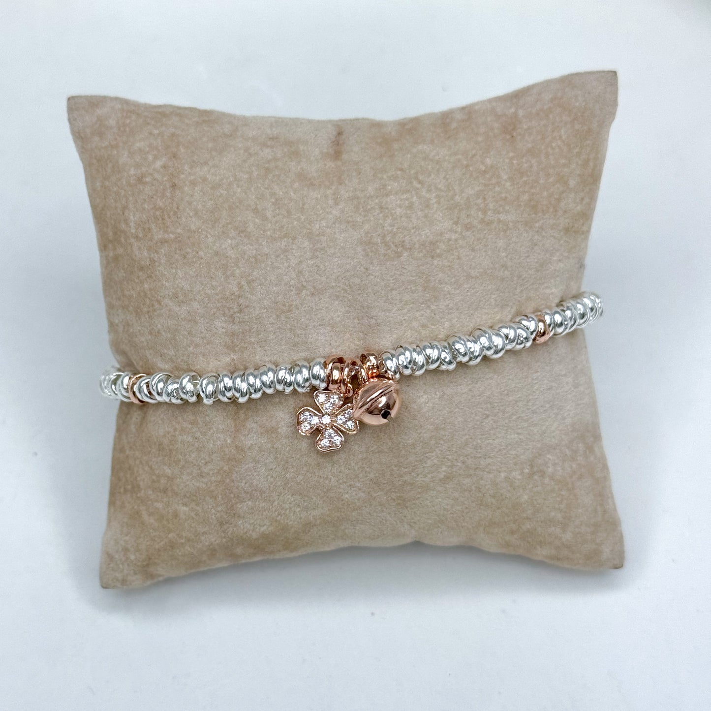 Bracciale rondelle rodio con campanellino e quadrifoglio zirconi rosè