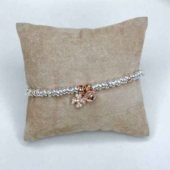 Bracciale rondelle rodio con campanellino e quadrifoglio zirconi rosè