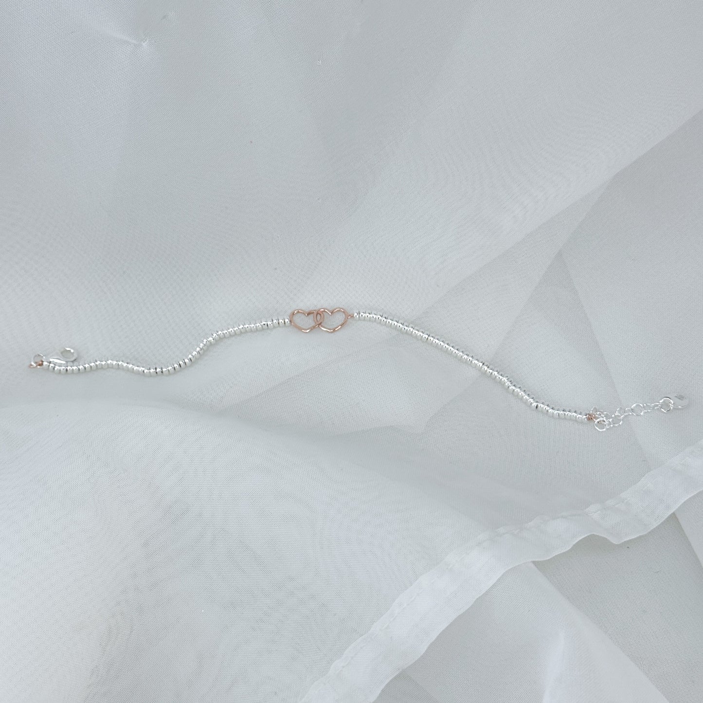 Bracciale in argento con cuori intrecciati rosé - Lumiere Bijoux