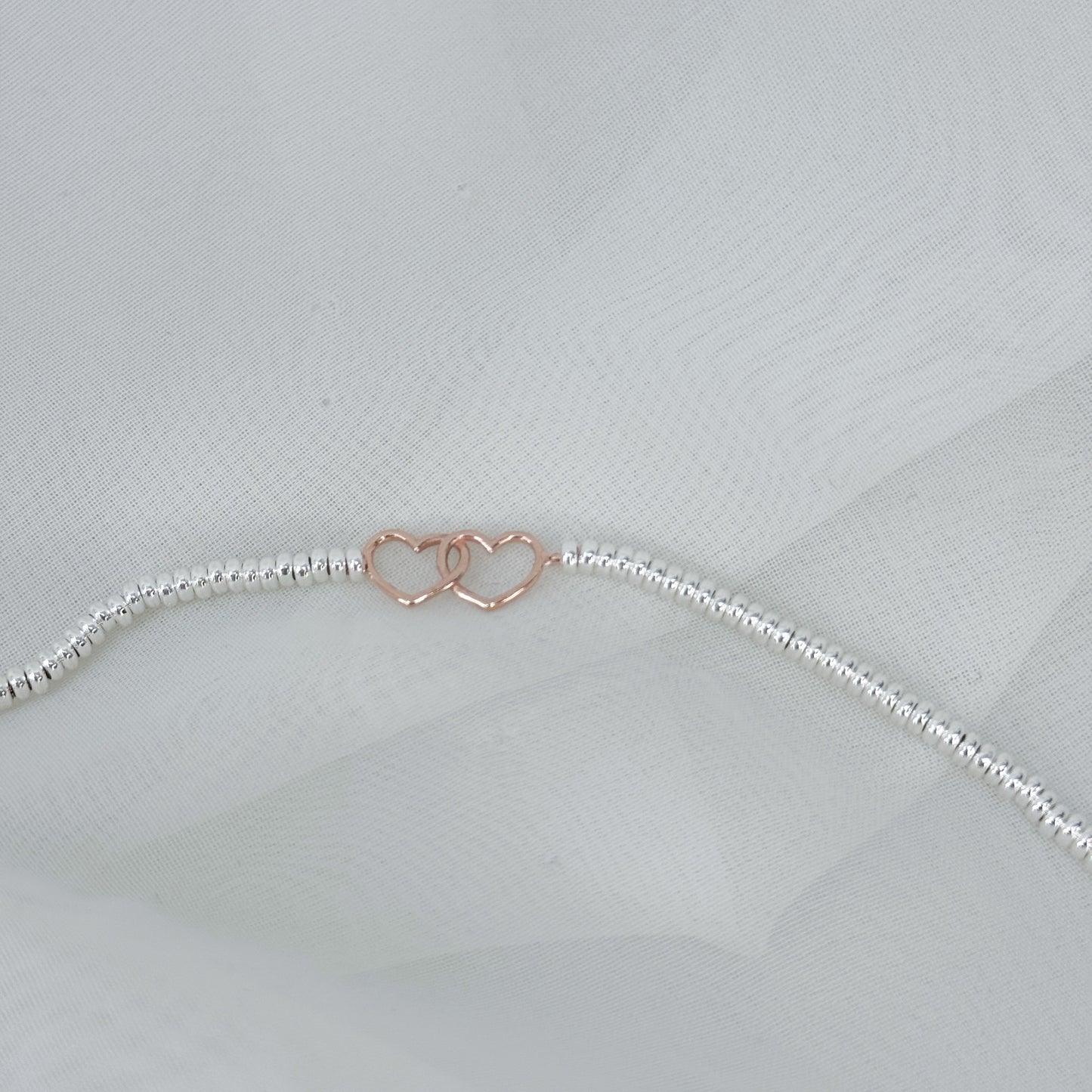 Bracciale in argento con cuori intrecciati rosé - Lumiere Bijoux